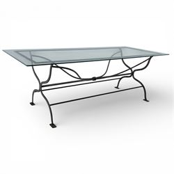 Late 20th century glass dining table, toughened glass top with rounded corners on a wrough...