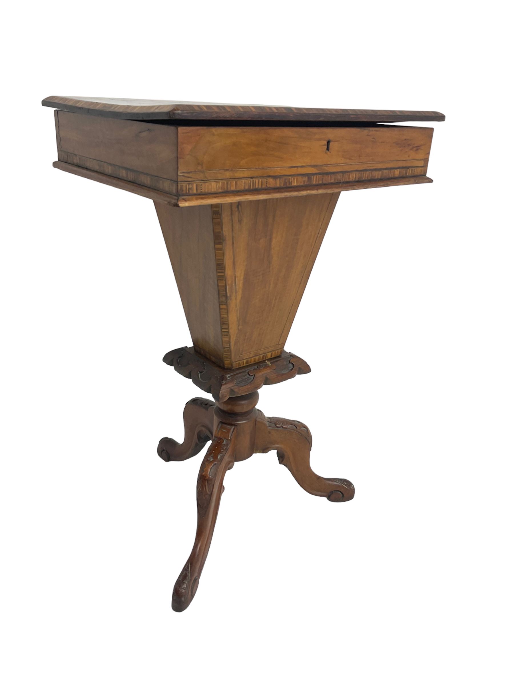 Victorian walnut work table, the rectangular hinged top inlaid with a chessboard design, canted edge with alternating ebony and satinwood inlays, concealing fitted interior, banded and strung frieze over tapering column well, collar carved with foliate decoration, on a cabriole tripod base