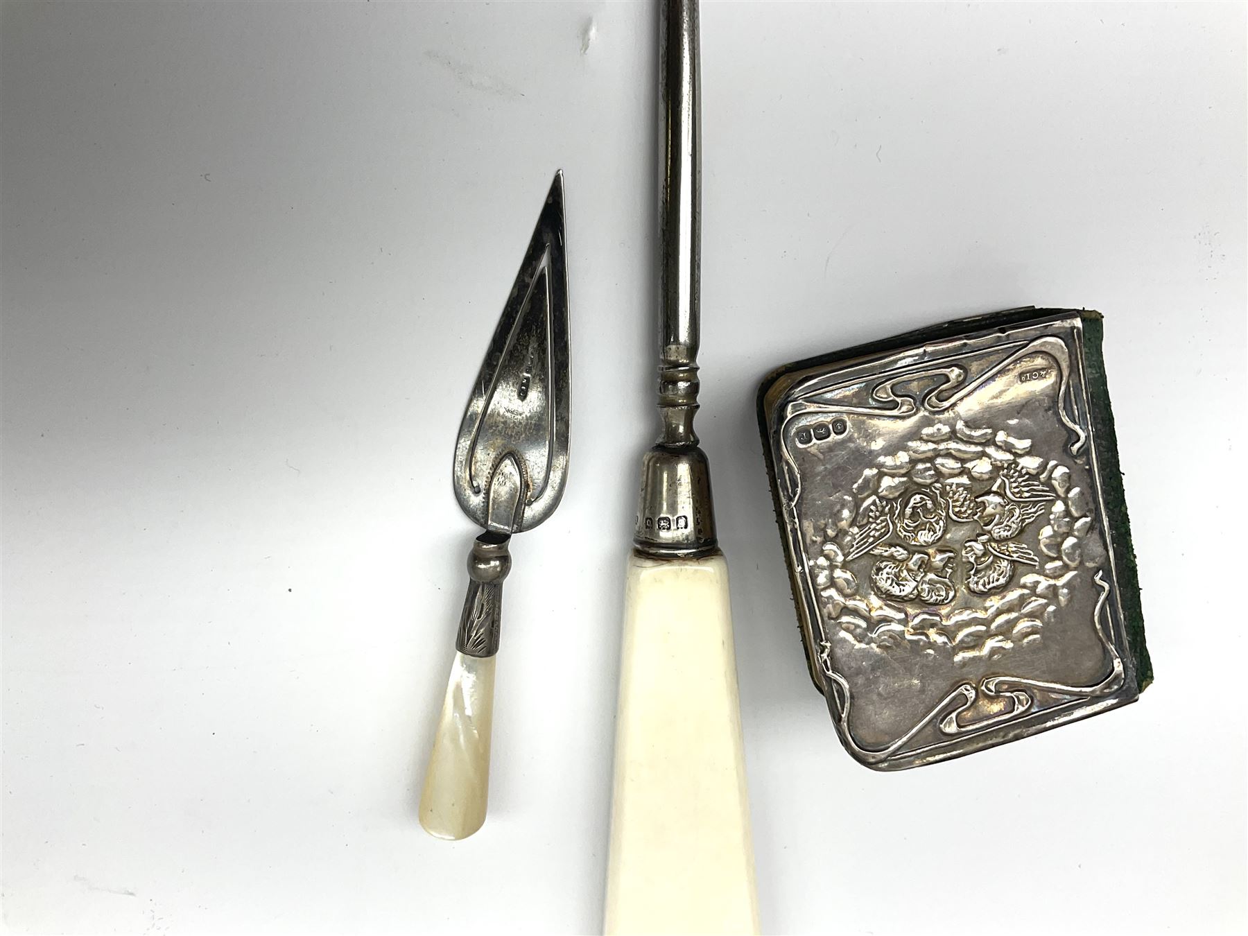 Cased silver handled glove stretcher, button hook, shoe horn, etc., hallmarked Adie & Lovekin Ltd, Chester 1911, and Adie & Lovekin Ltd, Birmingham 1911, miniature silver mounted hymn book, the cover embossed with cherubs, silver handled button hook, ivory handled button hook with silver ferrule, two silver dressing table pot lids, etc. 
