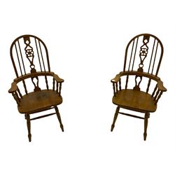 Set of six lightwood Windsor style dining chairs, hoop and stick backs with pierced wheel splats, turned supports joined by H stretchers, two carvers and four side chairs