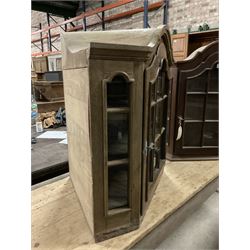 Dutch design oak wall hanging apothecary cabinet, of arched form with single astragal style glazed door enclosing single shelf (W69cm D18cm H69cm); together with another similar of corner form (W75cm D48cm H69cm) - THIS LOT IS TO BE COLLECTED BY APPOINTMENT FROM THE OLD BUFFER DEPOT, MELBOURNE PLACE, SOWERBY, THIRSK, YO7 1QY