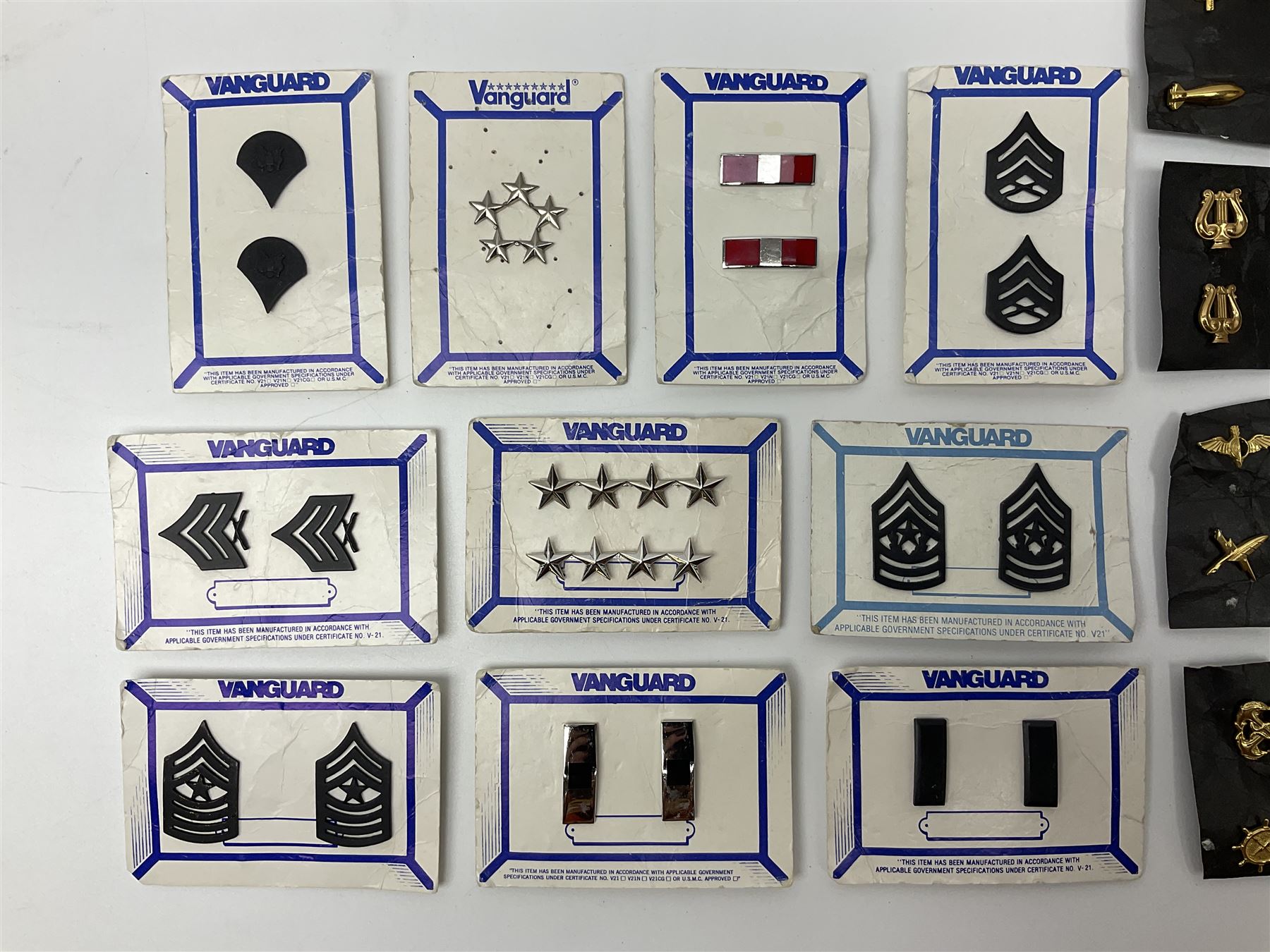 Fifty US rank badges and trade badges; WW2 and Vietnam period; predominantly on sale cards