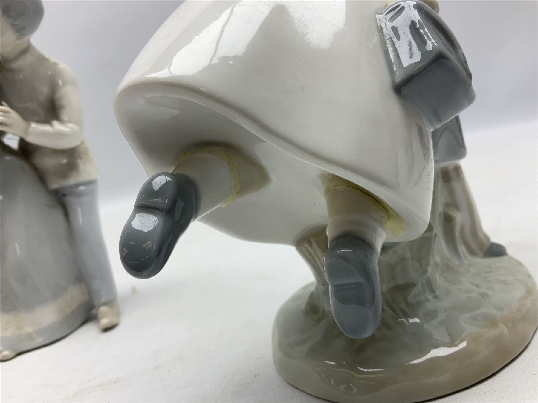 Three Nao figures comprising The Next Dance 1201 and Girls First Communion 0236, and young girl wearing a hat, together with two further Spanish style figures