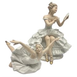 Two Wallendorf figures of ballerinas, the first modelled in extravagant dress seated with a mirror, no. 1396, the second in Swan Lake style dress in dramatic flying ballerina floor pose with her arms outstretched, no. 1694, both detailed with gilt and impressed and printed marks beneath, largest H25cm