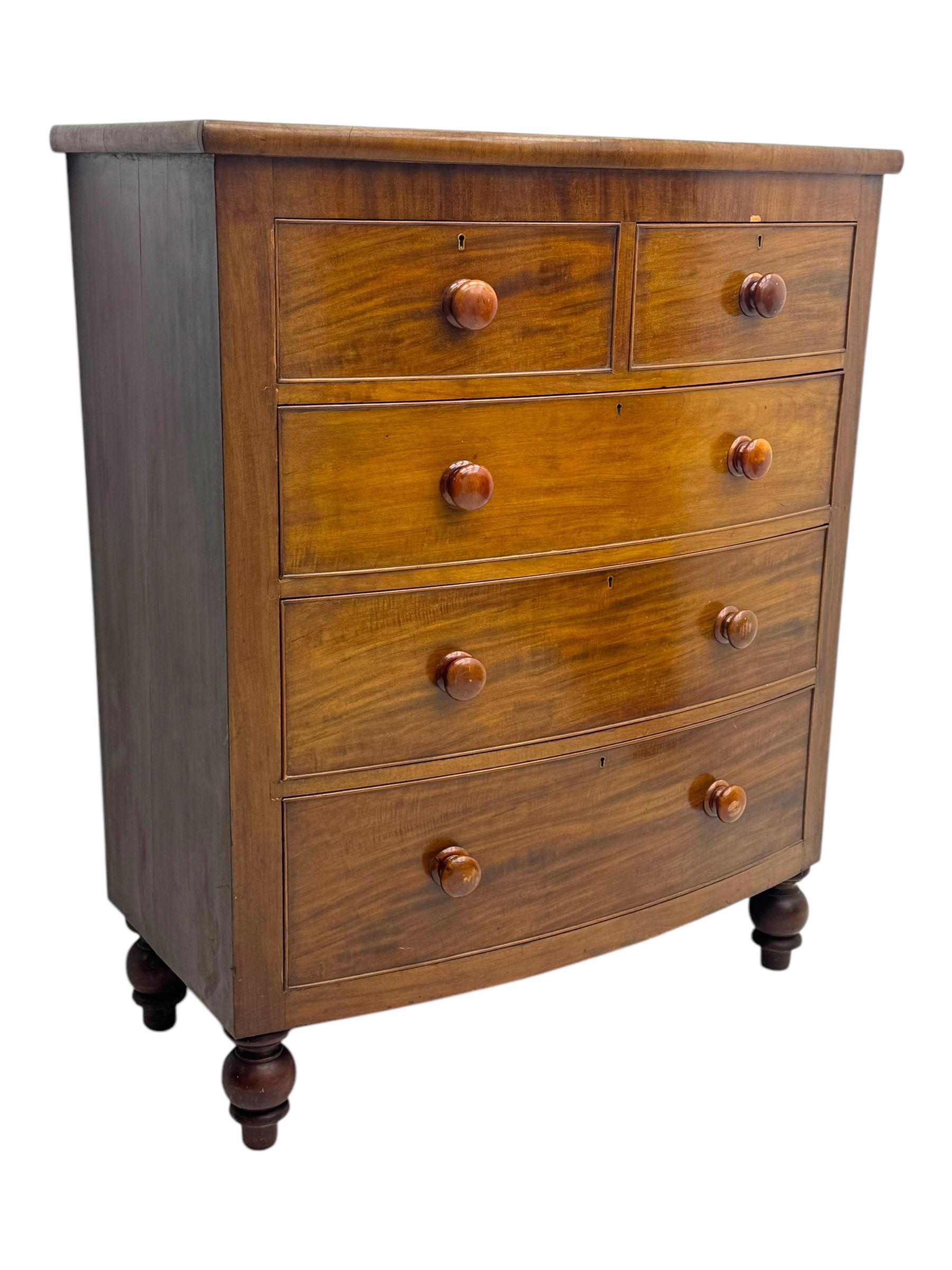 Victorian mahogany bow-fronted chest, fitted with two short over three long graduated cockbeaded drawers, on turned bun supports