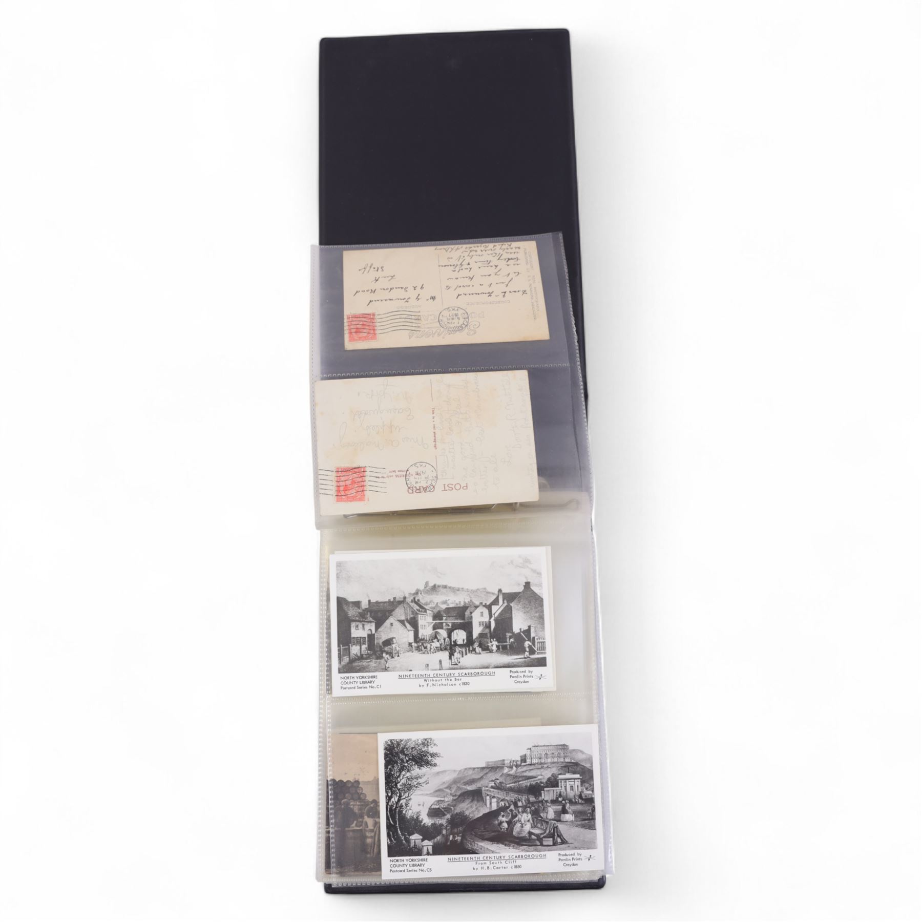 Collection of Scarborough postcards, mostly black and white examples, in postcard album