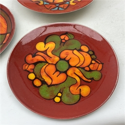 Three pieces of Poole Delphis Pottery, comprising a dish, shape 4, D26.5cm, and two plates, shape 4A, D25.5cm. 