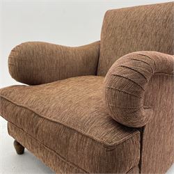Howard style club armchair, upholstered in maroon and beige ribbed fabric with loose seat cushion, turned front feet and splayed rear feet fitted with brass castors