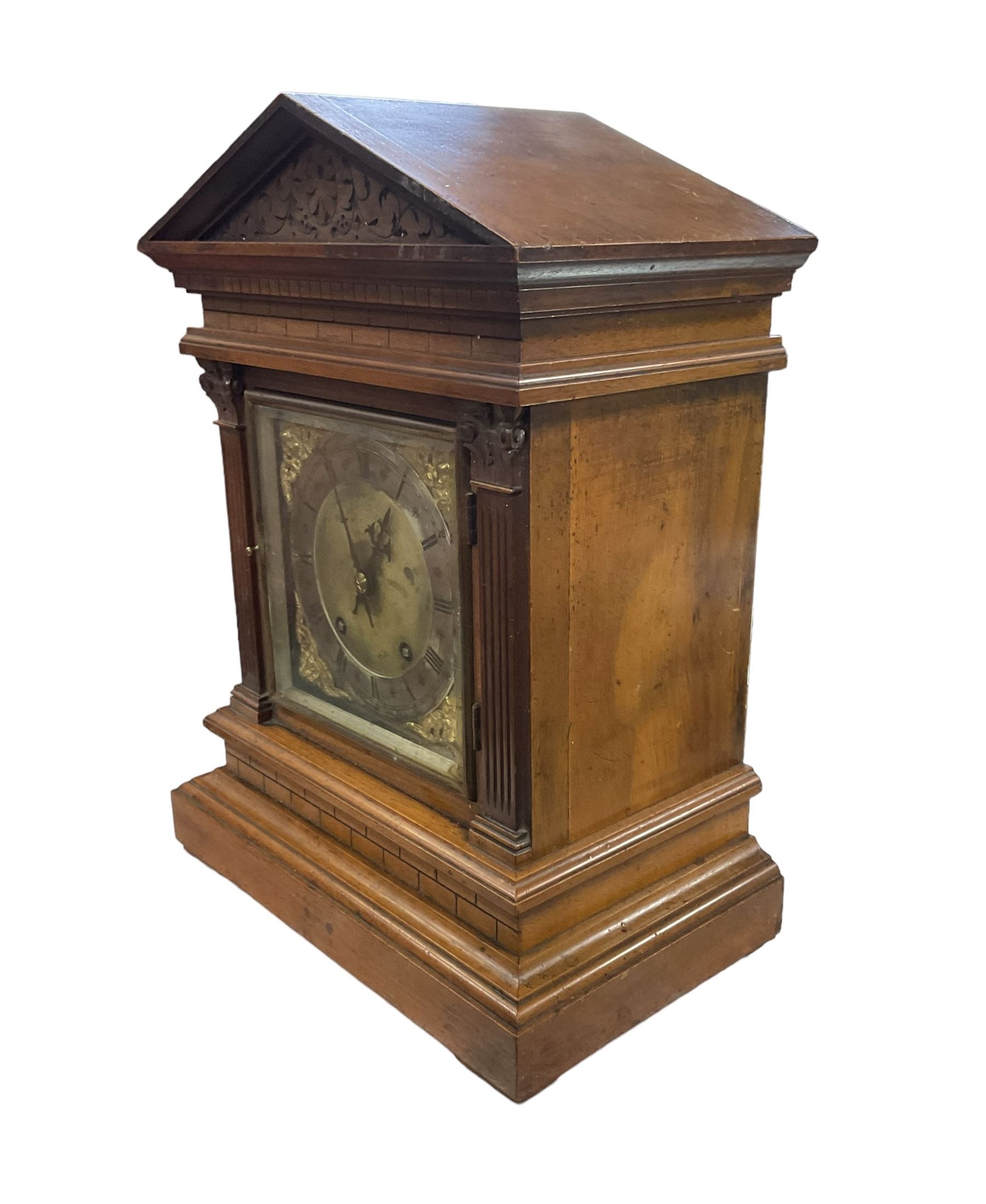 Winterhalder & Hofmeier - late 19th century Mahogany 8-day twin train mantle clock , with an architectural pediment  and carved tympanum, carved reeded pilaster to the front on a stepped plinth with  brickwork relief, square brass dial with cherub spandrels, matted dial centre and silvered chapter ring, dial pinned to a 