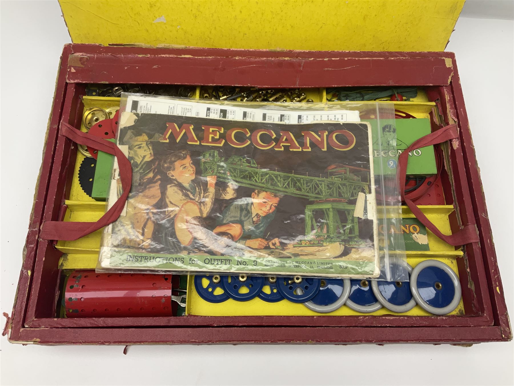 Meccano Outfit No.9 - with good quantity of red and green plates, strips, wheels, brackets, trunnions, tyres, cylinders etc; original box with lift-out tray and instruction manual