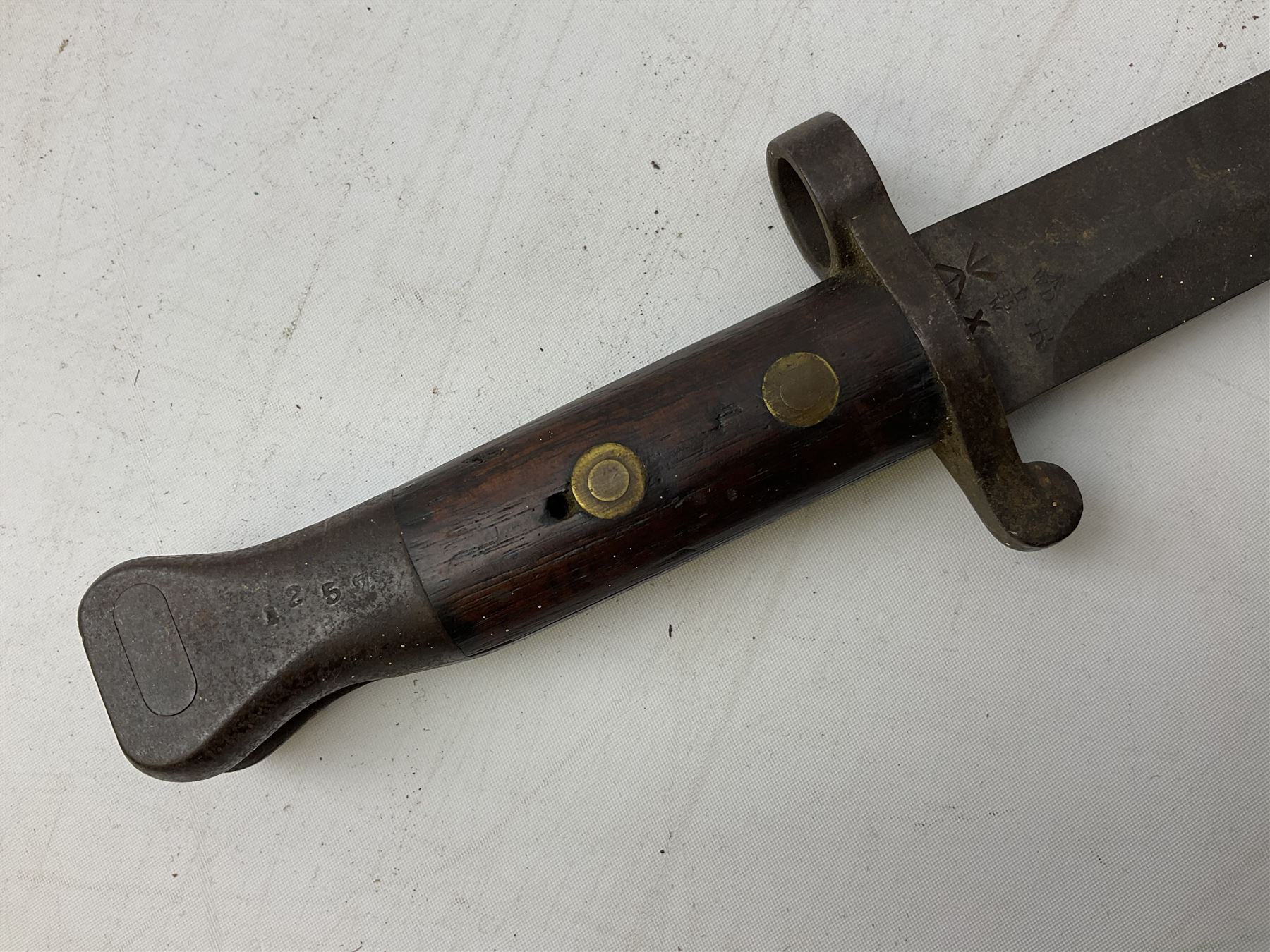 British Pattern 1907 bayonet with 43.5cm fullered steel blade; in leather scabbard with webbing frog L58cm overall; another Pattern 1907 bayonet lacking scabbard; and British Pattern 1888 Mk.I bayonet by Wilkinson London (no scabbard) (3)