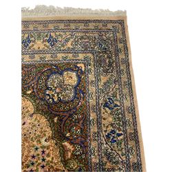 Persian design peach ground rug, tree of life design with trailing leafy branches and decorated with flower heads, scrolled spandrels with stylised plant motifs, guarded border with repeating floral pattern 