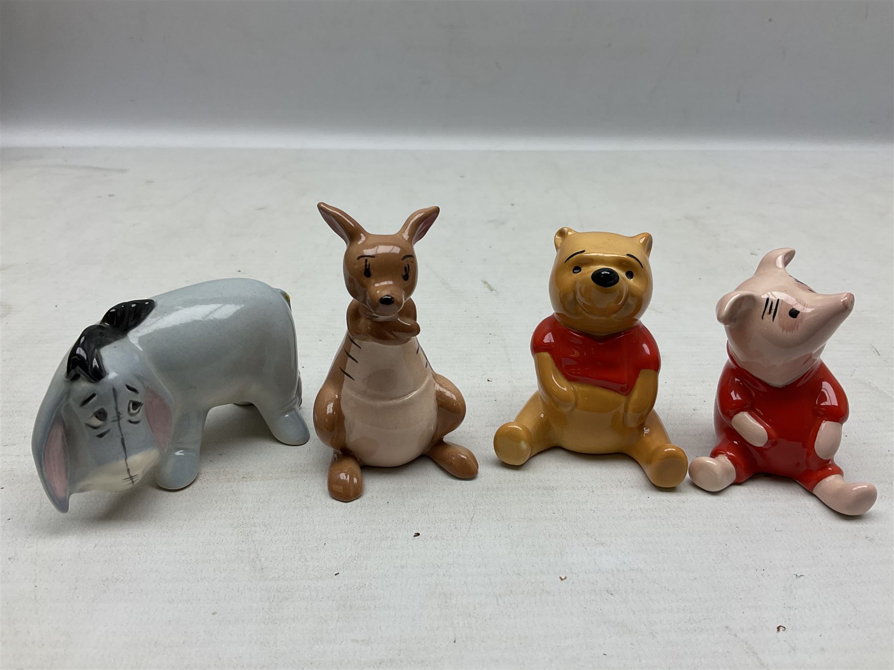 Set of eight Winnie the Pooh Beswick figures, comprising Christopher Robin, Winnie the Pooh, Tigger, Piglet, Rabbit, Eeyore, Owl and Kanger, six with original boxes, tallest H12cm  