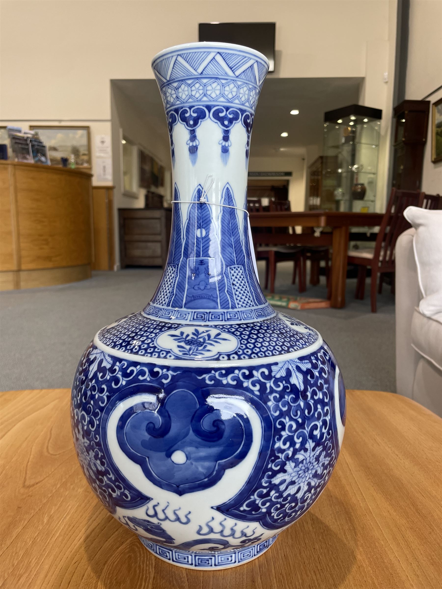 Late Qing Dynasty bottle vase decorated in blue and white with dragons and pearls, stylised leaves and flowers with key pattern foot H40cm 