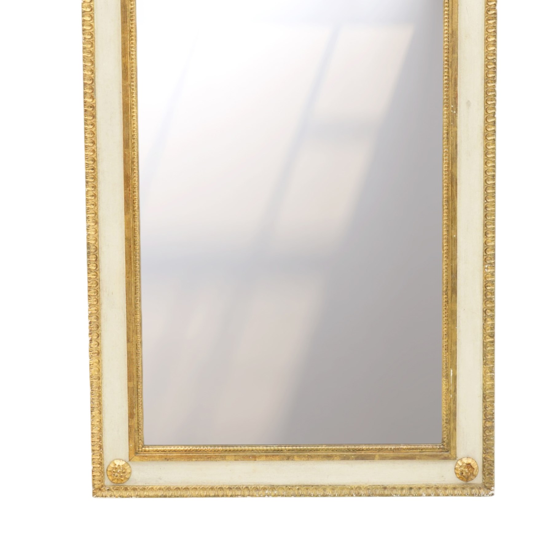 Neoclassical design pair of cream painted and gilt pier mirrors, projecting moulded cornices above frieze panels decorated with ribbon-tied musical trophies, rectangular plates within beaded slips, the outer frames with repeating leaf borders and flowerhead roundels