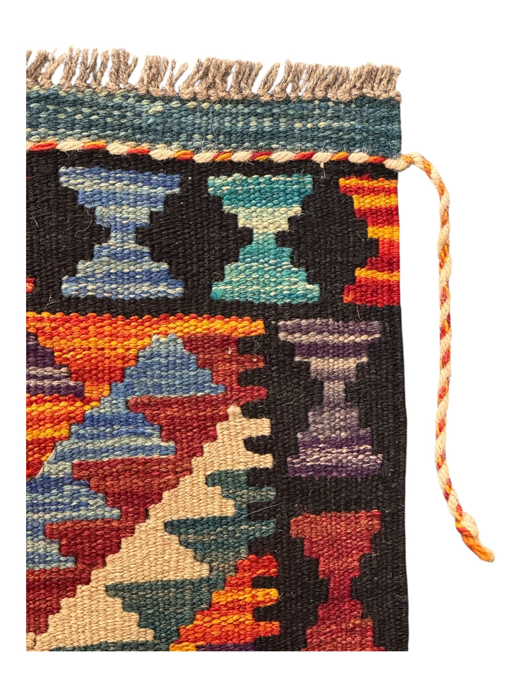 Afghan Maimana flatweave Kilim rug, the field decorated with multi-coloured diamond motifs in a stepped formation, framed by a bold hourglass border,