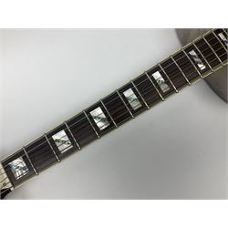 Ozark metal cased resonator guitar with all over chased foliate decoration to the polished finish and mother-of-pearl inlay to the fretboard L100cm; in Stagg hard carrying case