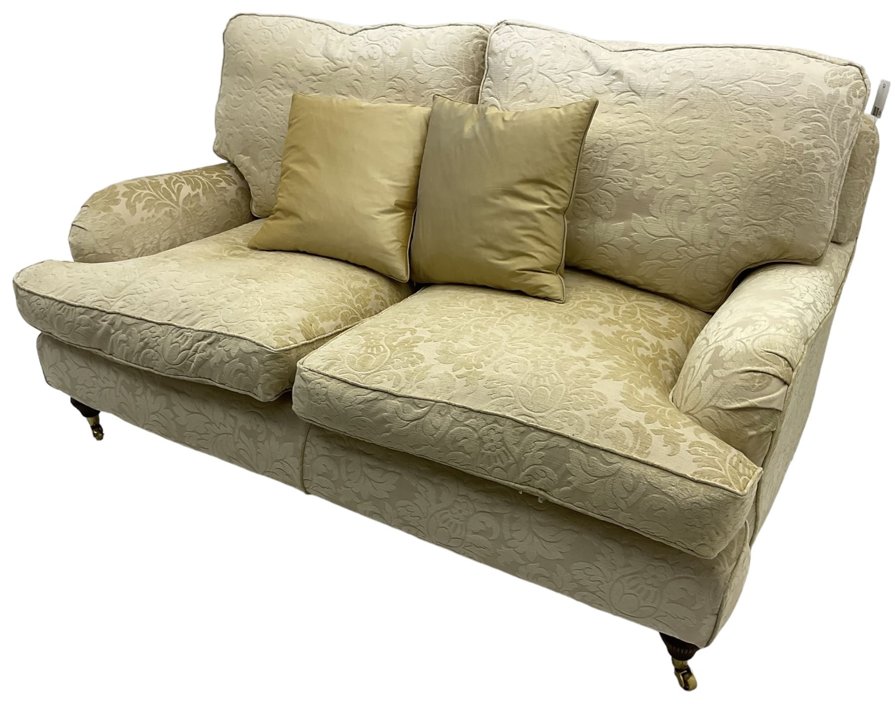 Multi-York - Howard shape two-seat sofa, upholstered in scrolling floral pattern loose covers, rolled arms, on turned front feet with brass cups and castors