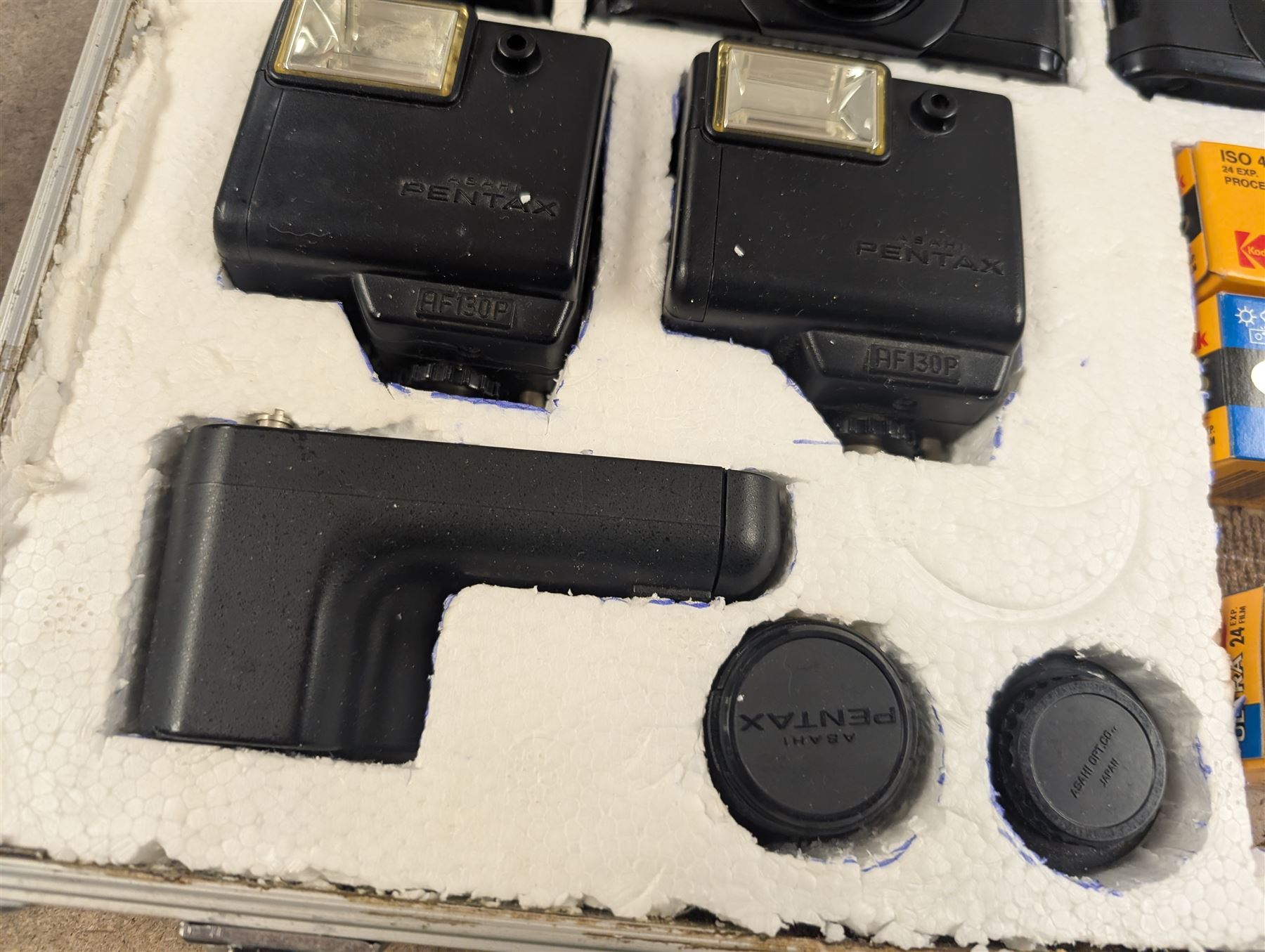 Two Pentax Auto 110 camera bodies and accessories including flashes, winder and lenses, all within two flight cases