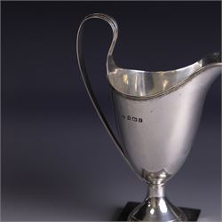Edwardian silver helmet shaped cream jug, upon a square base, hallmarked John Rose, Birmingham 1905, together with a 1930s silver christening mug with engraved initials to body, hallmarked Aaron Lufkin Dennison, Birmingham 1936, jug including handle H13cm