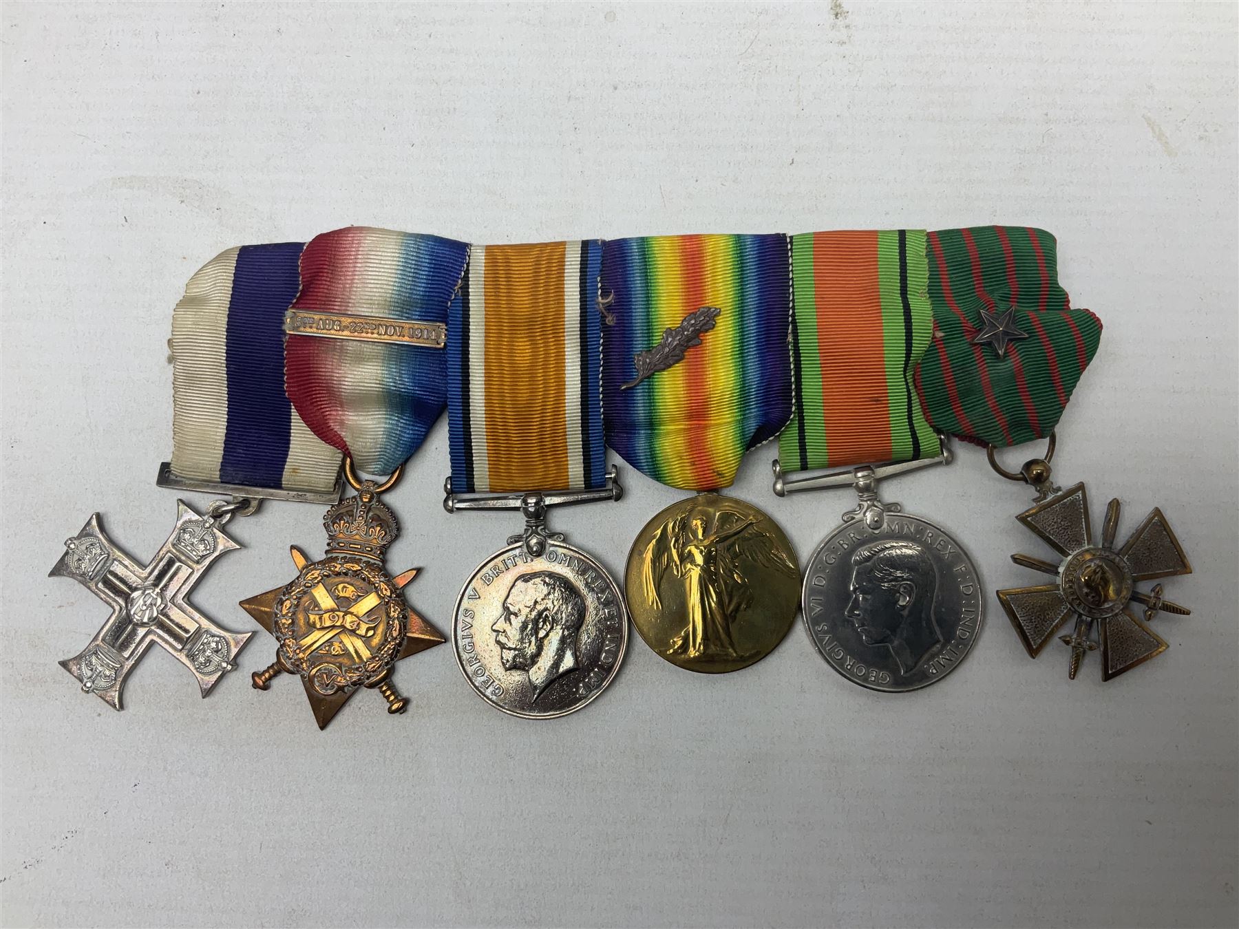 WW1/WW2 Military Cross group of five medals comprising M.C., 1914 Star with date clasp to 34156 Sjt. G. Ferguson R.F.A., British War Medal and Victory Medal with MID leaves to Major G. Ferguson, WW1 French Croix De Guerre with MID Star and WW2 Defence Medal; all with ribbons on pinned wearing bar; WW1 group of five miniature dress medals; two Royal West Kent cap badges; early 20th century silver cigarette case engraved with GF monogram and adapted as a photograph holder with image of Ferguson in civilian clothing; presentation Rotary 9ct gold cased wrist-watch with 1931 British Legion inscription verso; and archive of ephemera including 1914 MID certificate; WW2 Home Guard certificate; over twenty career spanning photographs of Regimental groups, portraits, Sandhurst etc; 1914 Commission document to 2nd Lieutenant; 11th Brigade R.F.A. Roll of Honour 1914-18; 'Soldier's Small Book'; Army Book 439 etc