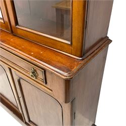 Victorian mahogany bookcase on chiffonier, projecting banded cornice, upper section enclosed by two glazed doors, lower section fitted with single drawer over panelled double cupboard