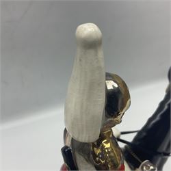 Mounted Lifeguard upon a black horse, in the style of Beswick, upon a wooden plinth, H31cm