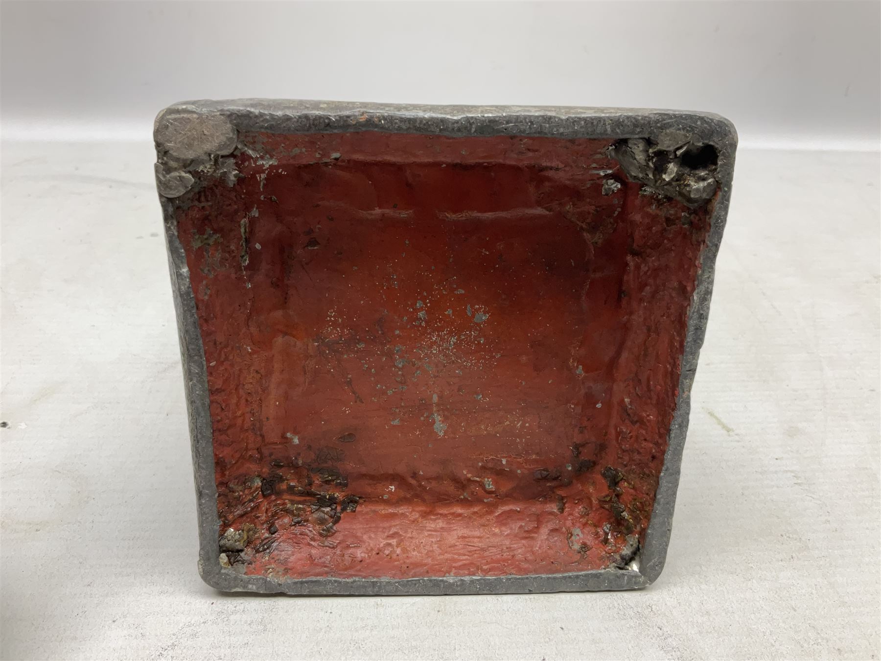 19th century lead tobacco box, the body of square form decorated with panels of courting couples in relief supporting stepped tapering lid with figural male head finial, H18.5cm