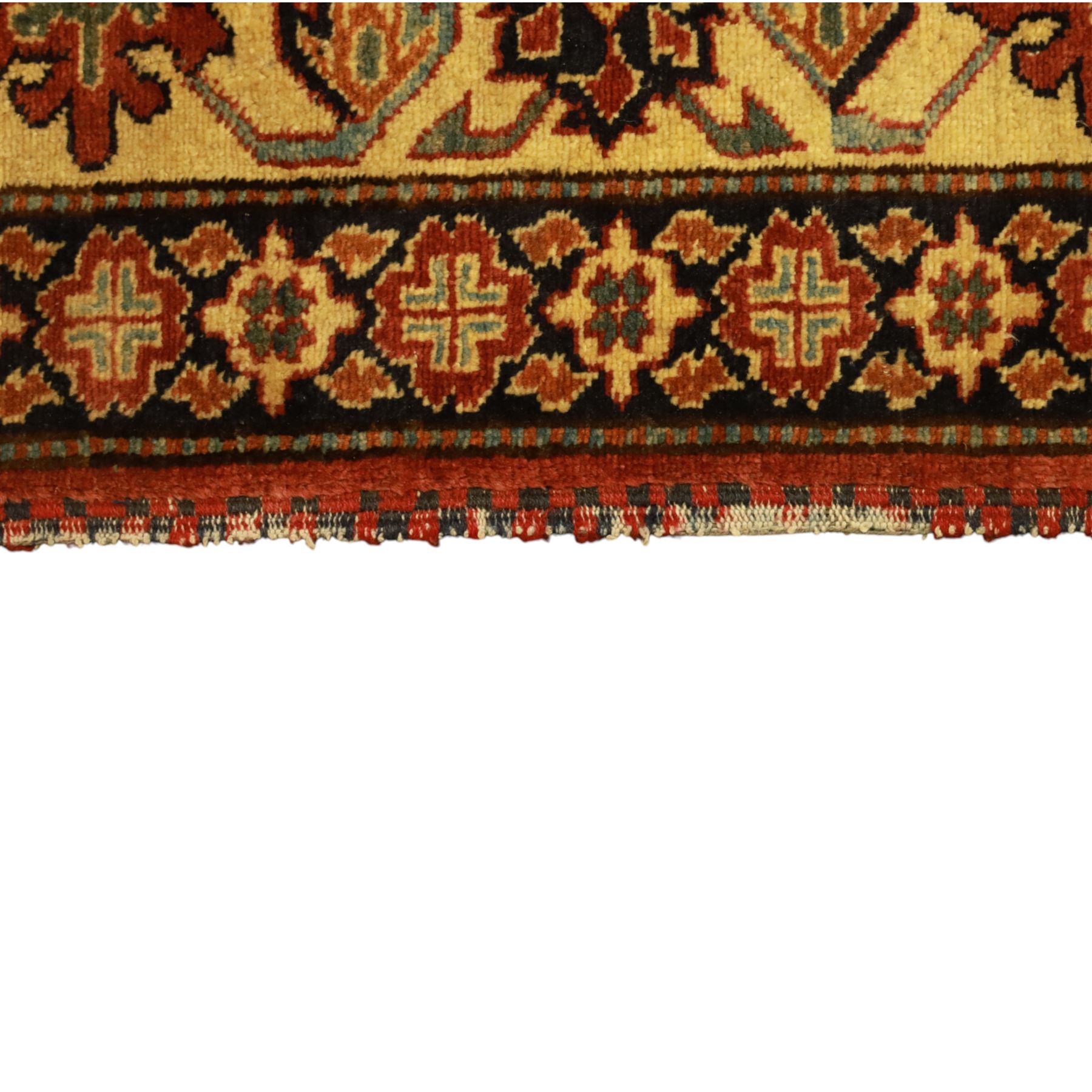 Afghan Gazni Kazak rug, the hand-knotted wool pile featuring a rust red ground with all-over geometric floral motifs in ivory and dark green, enclosed by a wide ivory border with stylised rosettes and angular vine decoration, fringed ends, from the region of Ghazni, Afghanistan