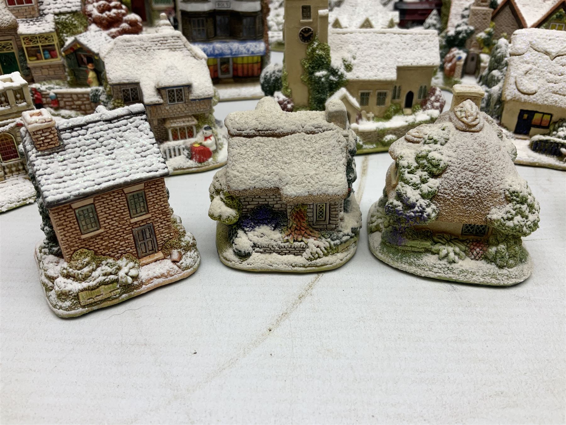 Five Lilliput Lane Illuminated Cottages, comprising Christmas is Coming, with box and deed, Christmas at Mol's, with box and deed, Christmas in Canterbury, with box and deed, Christmas Lights at Sweet Delights and The Three Kings, with box and deeds, together with twelve other Lilliput lanes, to include The First Noel, with box and deed, Winters Moonlight, Yuletide treats, with box and deed etc (17)