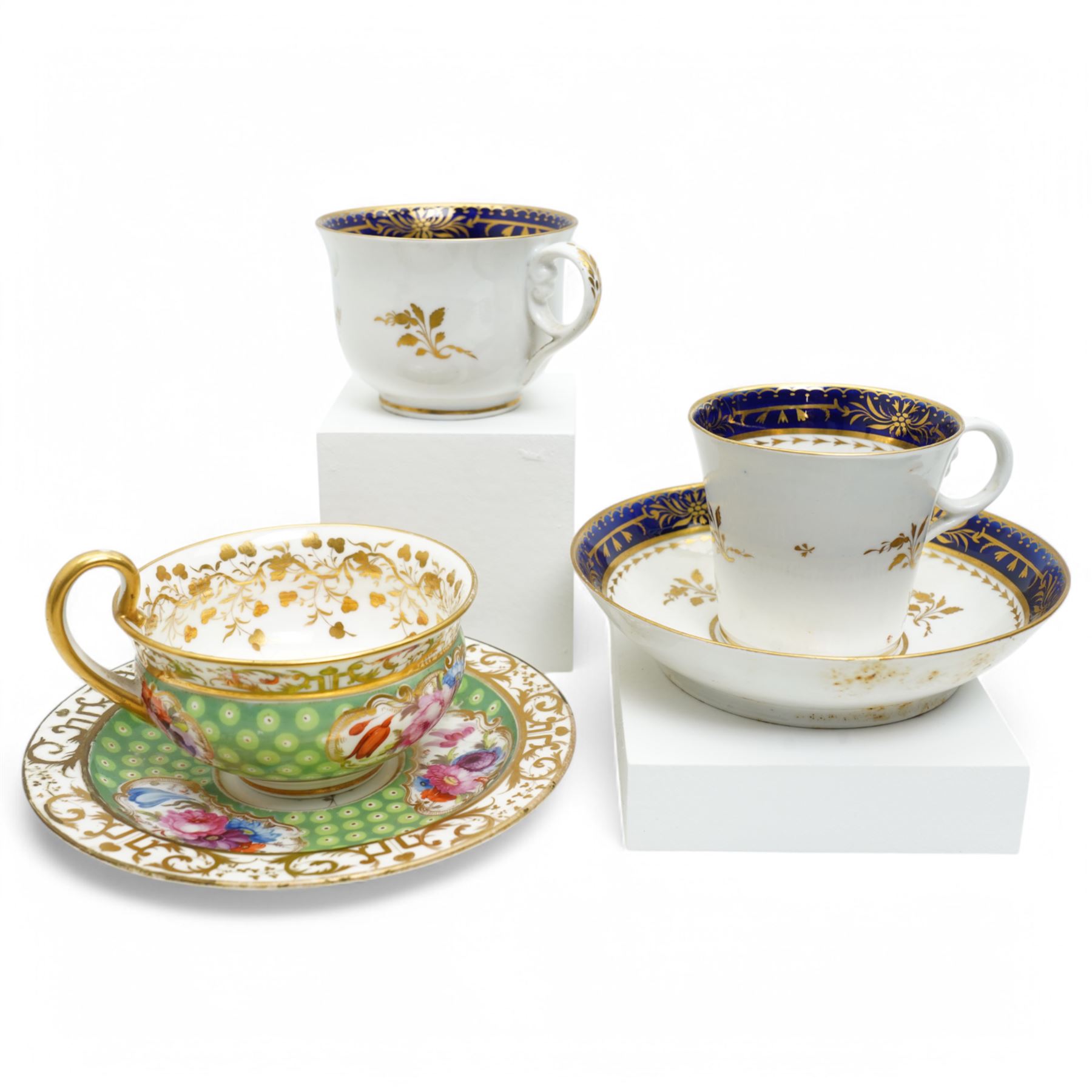  19th century Coalport Felt Spar porcelain cup and saucer painted with panels of flowers on a green and gilt ground and marked I Rose & Co and an early 19th century Worcester trio decorated in blue and gilt, Pattern No.274 