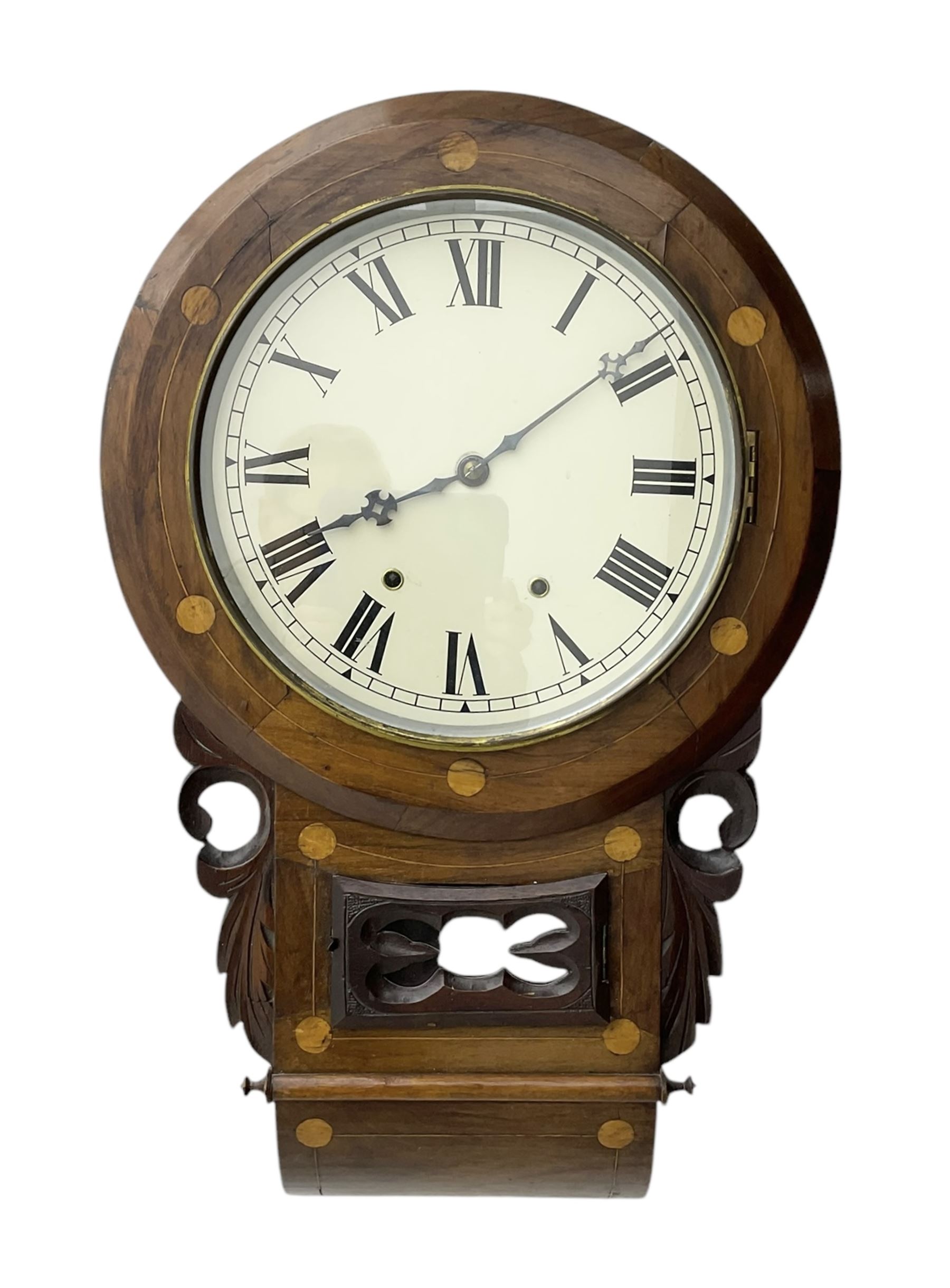 American- late 19th century 8-day mahogany drop dial wall clock, with a spun brass bezel and painted dial, Roman numerals, minute track and Maltese hands, case with an ogee base, satinwood inlay, carved case ears and a pendulum viewing door, twin train going barrel movement striking the hours on a bell. With pendulum. 
