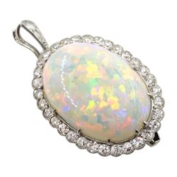 Early-mid 20th century platinum opal and diamond cluster pendant/brooch, the oval cabochon opal in a surround of old cut diamonds, milgrain set with detachable diamond bail

Notes: By direct decent from the Barraclough family. Zachariah Barraclough & Sons jewellers and silversmiths were established in Leeds in 1805 and in 1914 become a limited company