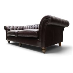 Thomas Lloyd - traditional shape Chesterfield two seater settee with rolled back and arms, upholstered in buttoned deep oxblood leather with loose seat cushions, raised on turned feet