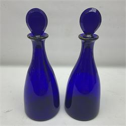 Pair of early 19th century blue glass decanters with teardrop stoppers, with gilt writing, the first marked Gin the second Brandy 