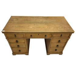 Late Victorian ash twin pedestal dressing table/desk, fitted with nine drawers, the centre drawer stamped 