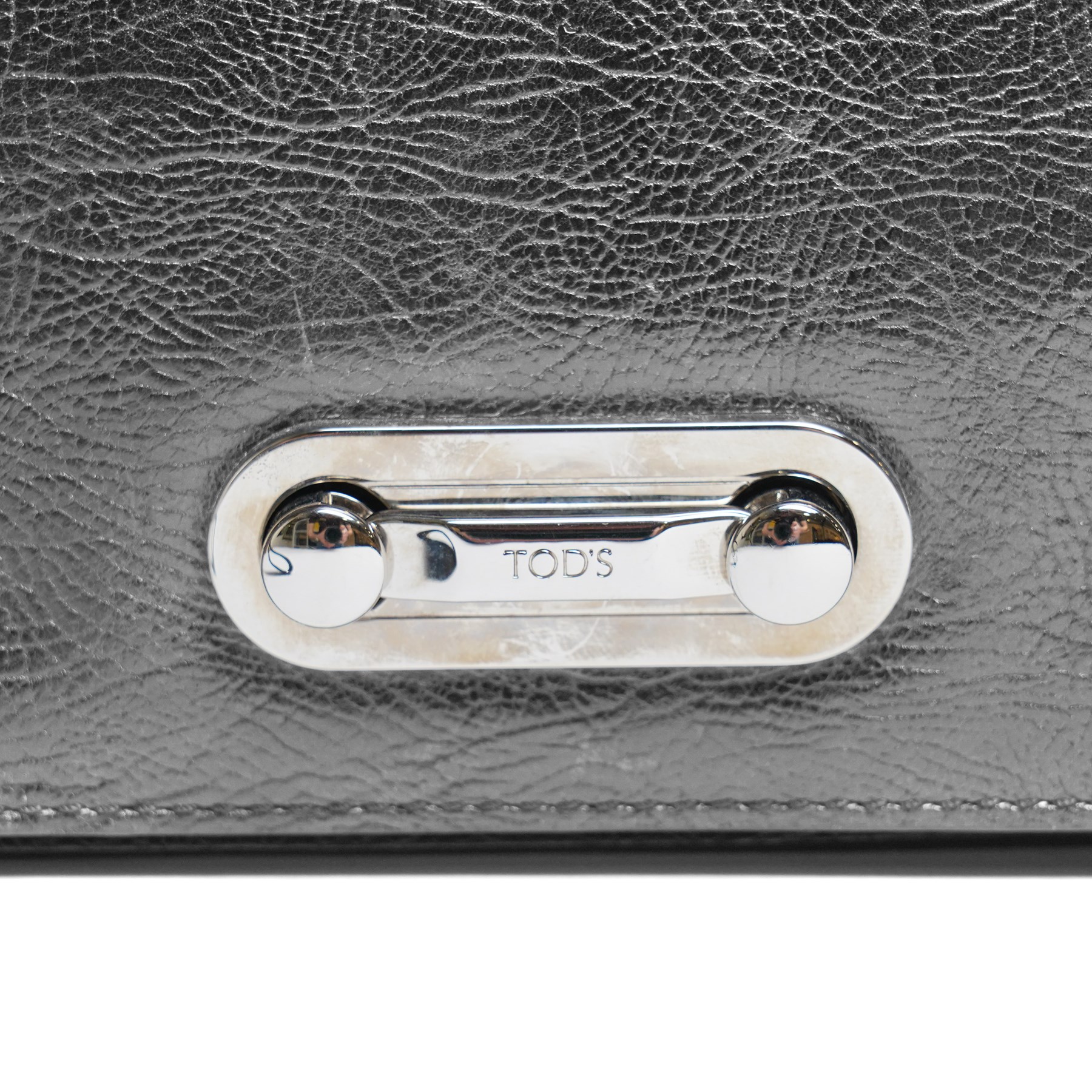 Tod’s - Fashion Pochette Piccola in Nero crinkled patent leather, the rectangular body with rolled-bar top, detachable wrist strap, flap front and silver-tone branded toggle fastening, with original product tag and dust bag