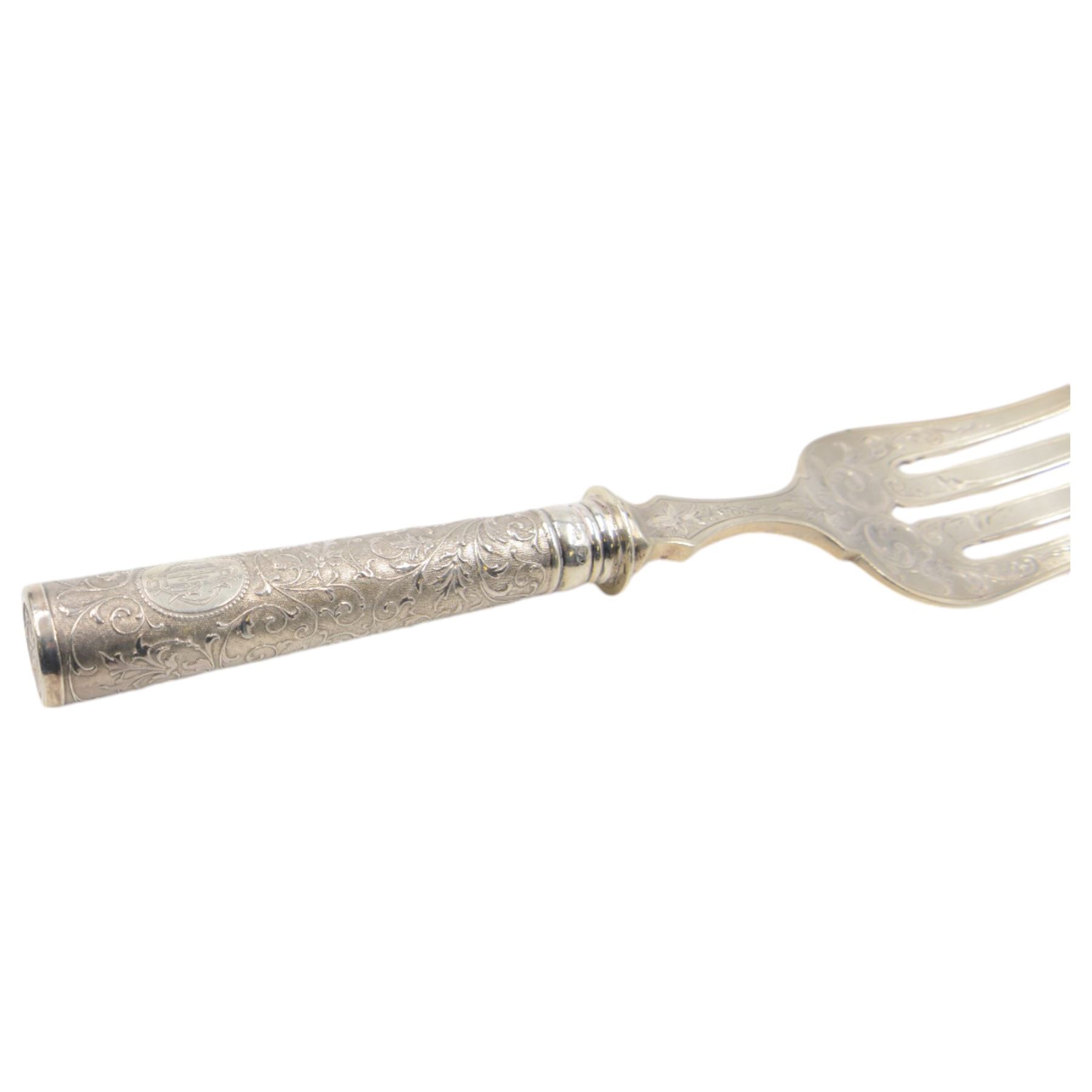 German silver handled four pronged fish serving fork, the tapering cylindrical handle with chased and repousse foliate decoration, engraved with monogram, stamped 800 with crescent and crown mark, L28cm

Notes: By vendor repute belonged to 7th Baron Brownlow 