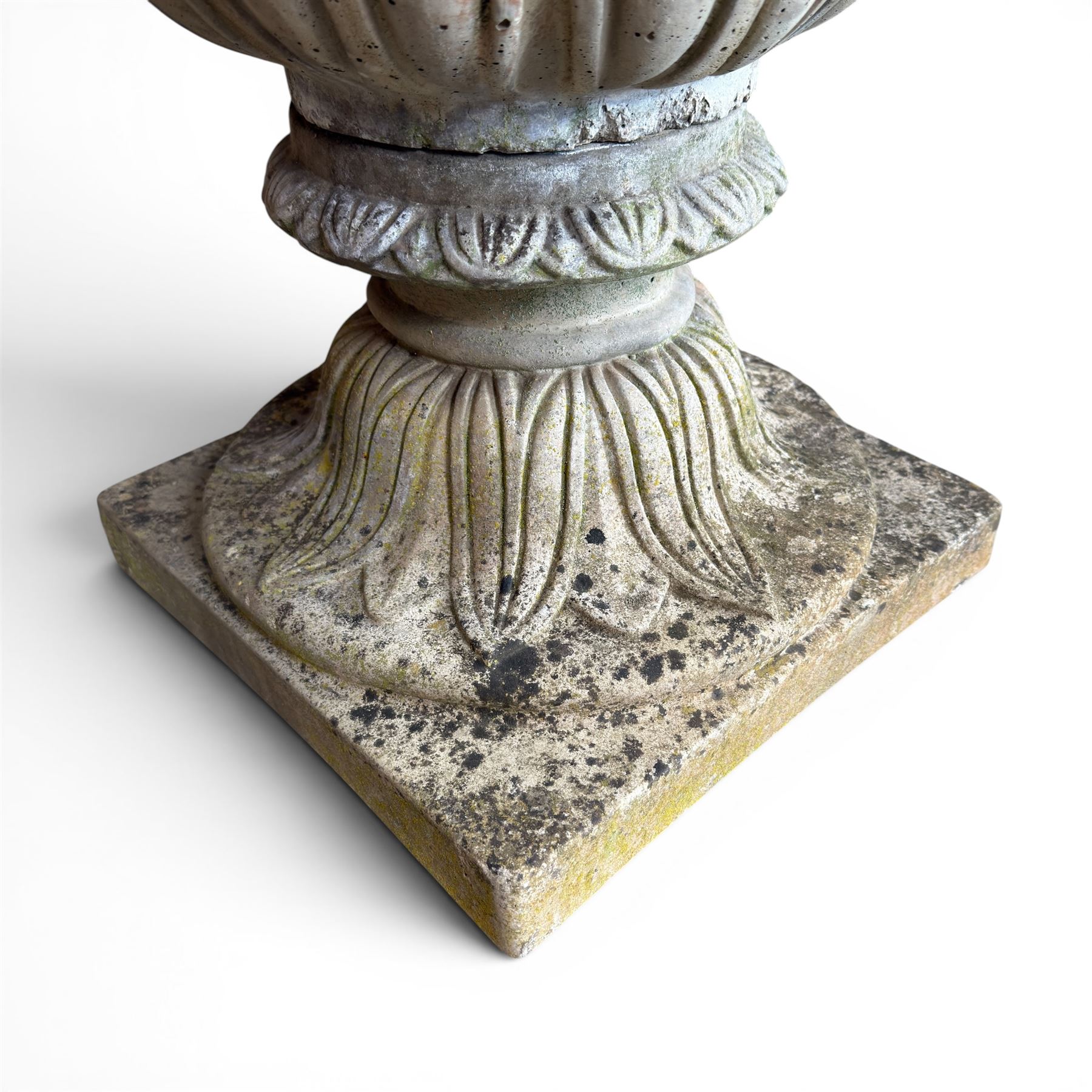 Cast stone tulip urn, petal rim with bell shaped bowl on squat base, stamped HGC; with associated plinth (2)
