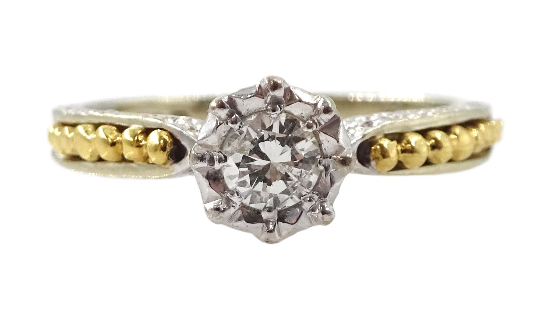 18ct white gold single stone diamond ring, with yellow gold bead design shoulders, London 1979, diamond approx 0.15 carat