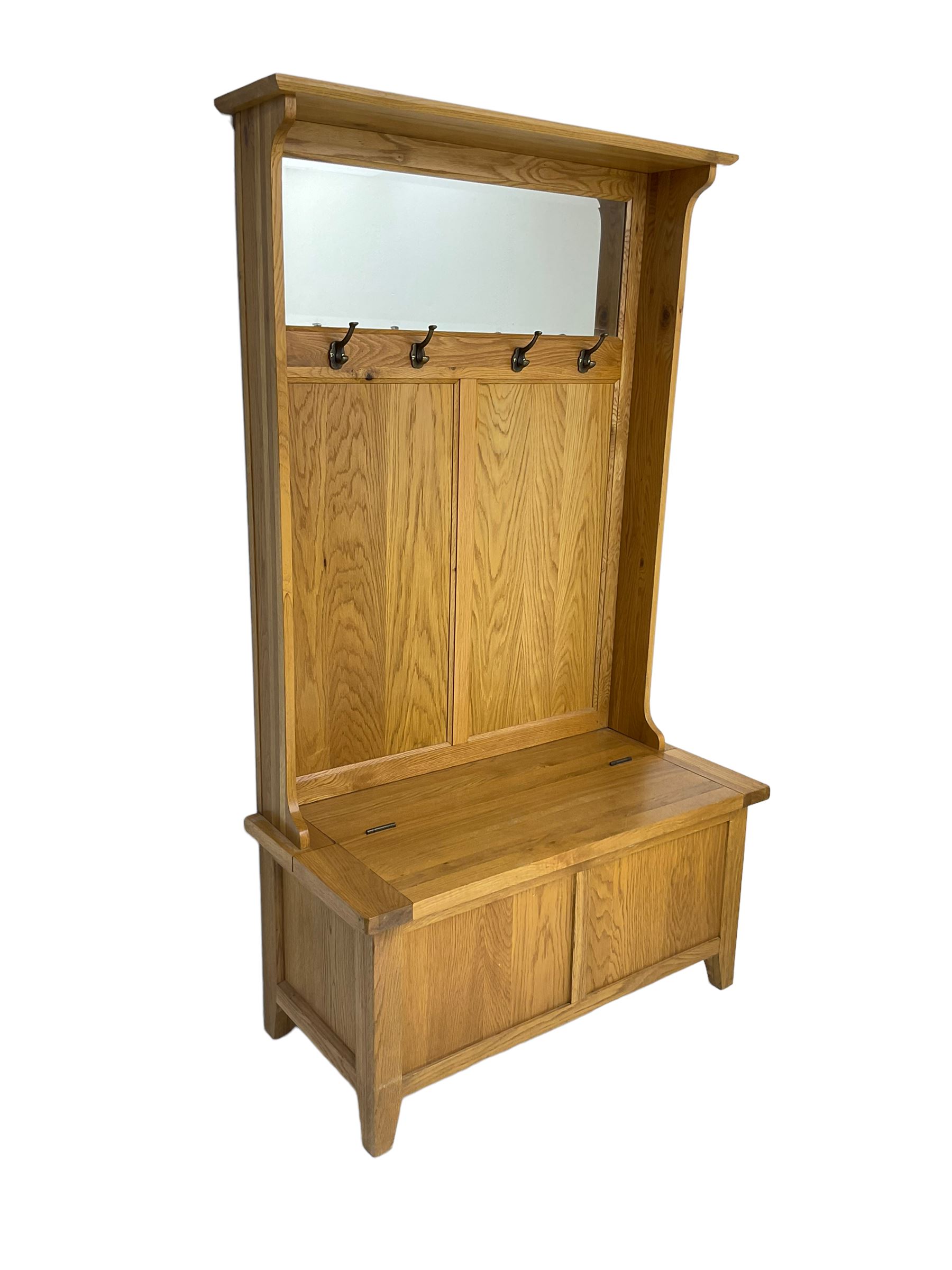Oak mirror-back hall bench, projecting cornice, rectangular bevelled plate over four coat hooks, hinged box seat compartment with panelled front, on square tapering feet