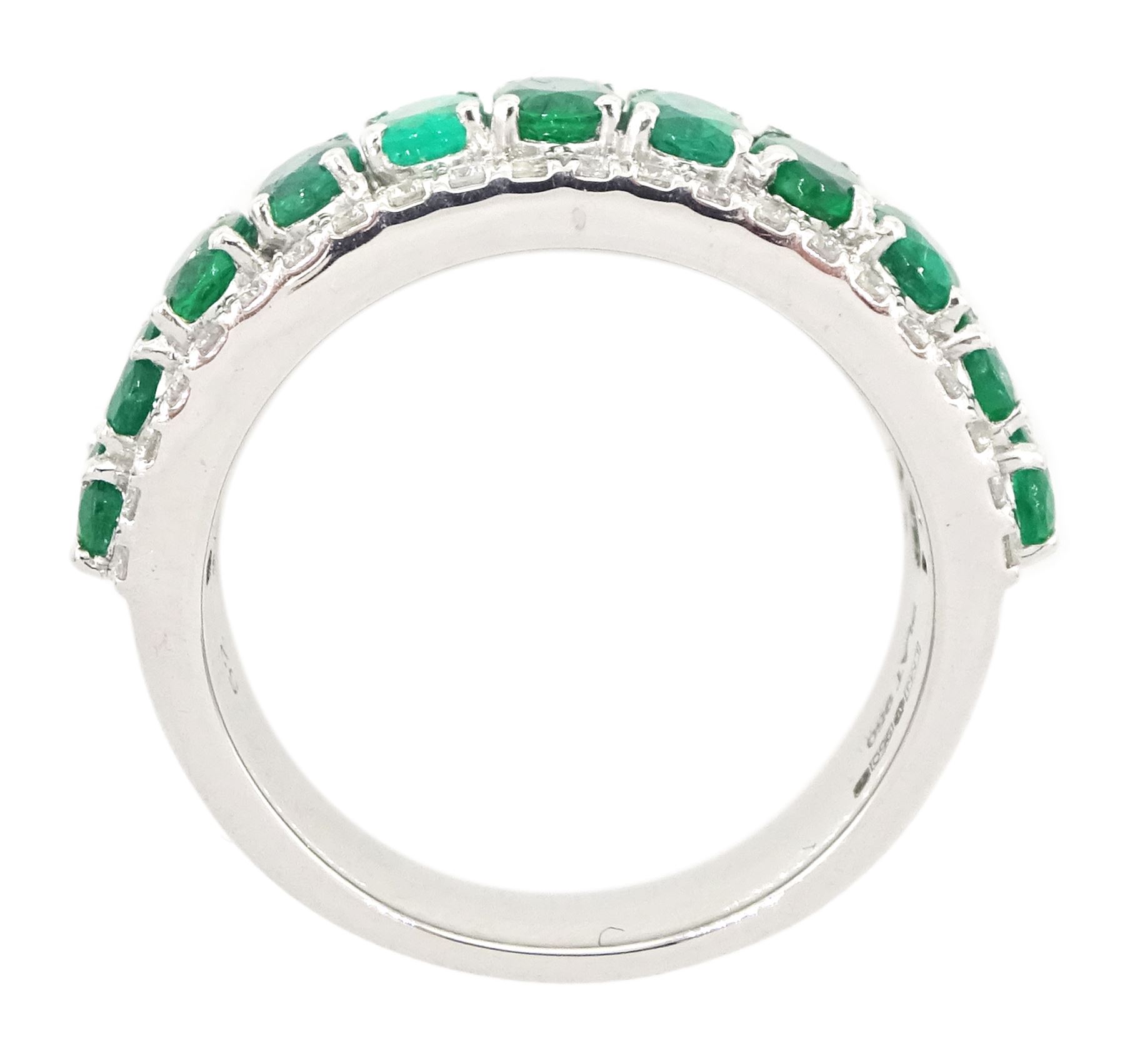 Platinum three row emerald and diamond half eternity ring, eleven oval cut emeralds with a row of round brilliant cut diamonds either side, hallmarked, total emerald weight approx 2.50 carat, total diamond weight approx 0.45 carat