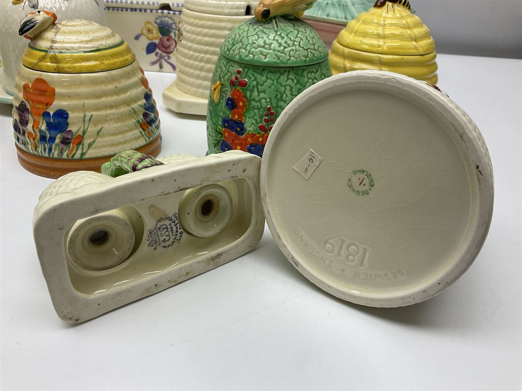 Clarice Cliff for Wilkinson Ltd Crocus Bizarre beehive honeypot painted in the Crocus pattern, together with two beehive Beswick honey pots, Poole square honey pot etc (14)