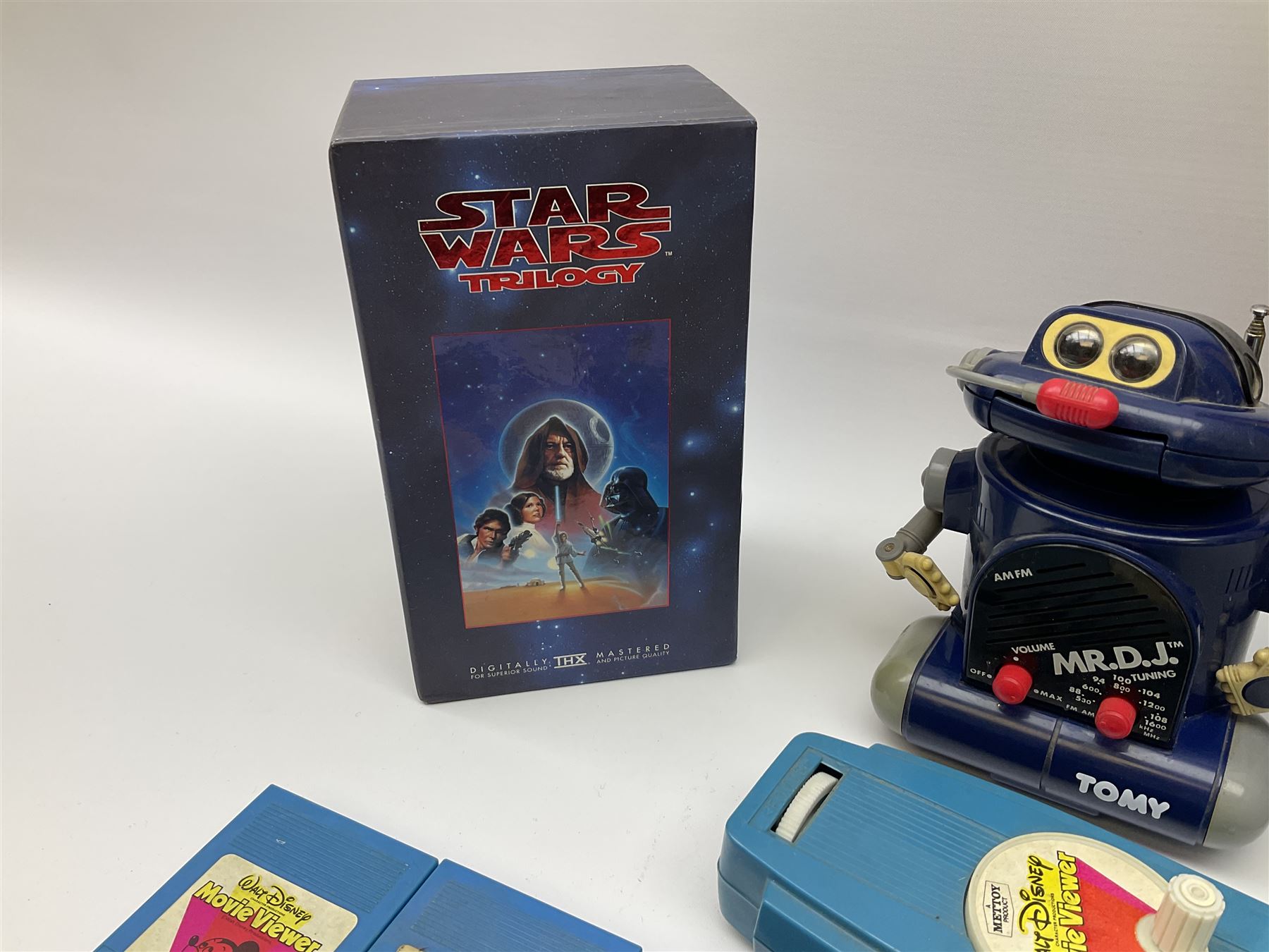 Matchbox 'The Thunderbirds' limited edition Commemorative Set, boxed with paperwork; Tomy 'Mr. D.J.' blue plastic robot radio; Mettoy Walt Disney Movie Viewer with three cassettes; and 1995 boxed set of the Star Wars trilogy VHS video tapes