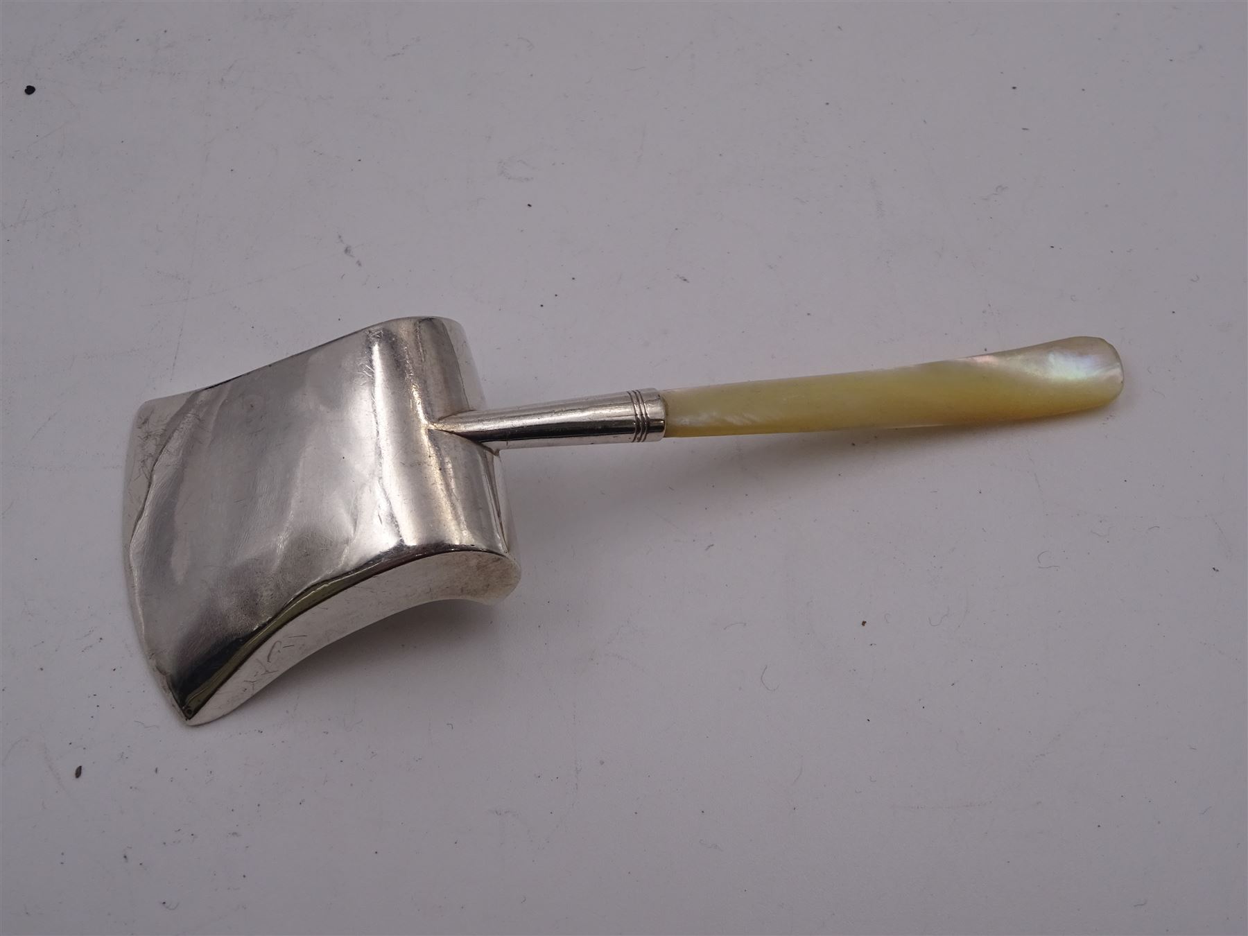 George III silver caddy spoon, of shovel form, with engraved foliate decoration and mother of pearl handle, hallmarked William Pugh, Birmingham 1809