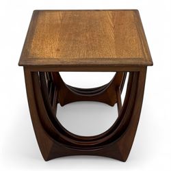 G-Plan - 'Astro' mid-century nest of three teak occasional tables, each with a square top with outer banding, on U-shaped end supports united by a stretcher