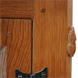 Rabbitman - oak sideboard adzed top with galleried top, with three graduating drawers to the centre, flanked by two panelled and lightly adzed doors, iron latches and hinges, raised on tapered stile supports, with carved rabbit signature, by Peter Heap of Wetwang   