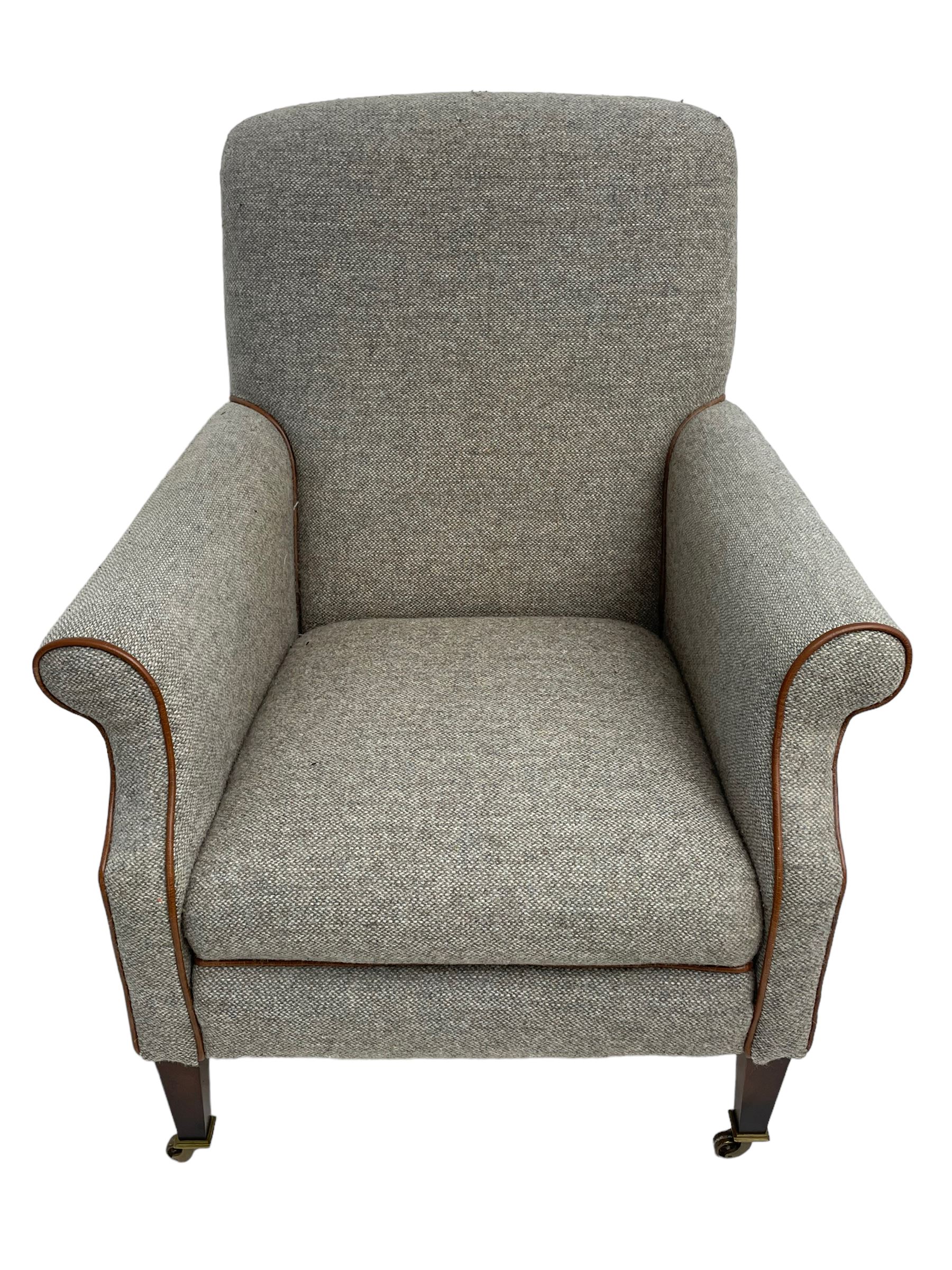 Interiors at Nine to Eleven - Edwardian design armchair, traditional shape with rolled arms, upholstered in 'Harris Tweed' fabric with leather piping, raised on square taping supports with castors