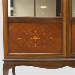 20th century Edwardian style mahogany display bookcase cabinet, the moulded cornice above two lancet glazed doors enclosing a shelved interior, the lower sections with oval inlaid fan decoration, supported on shaped cabriole legs