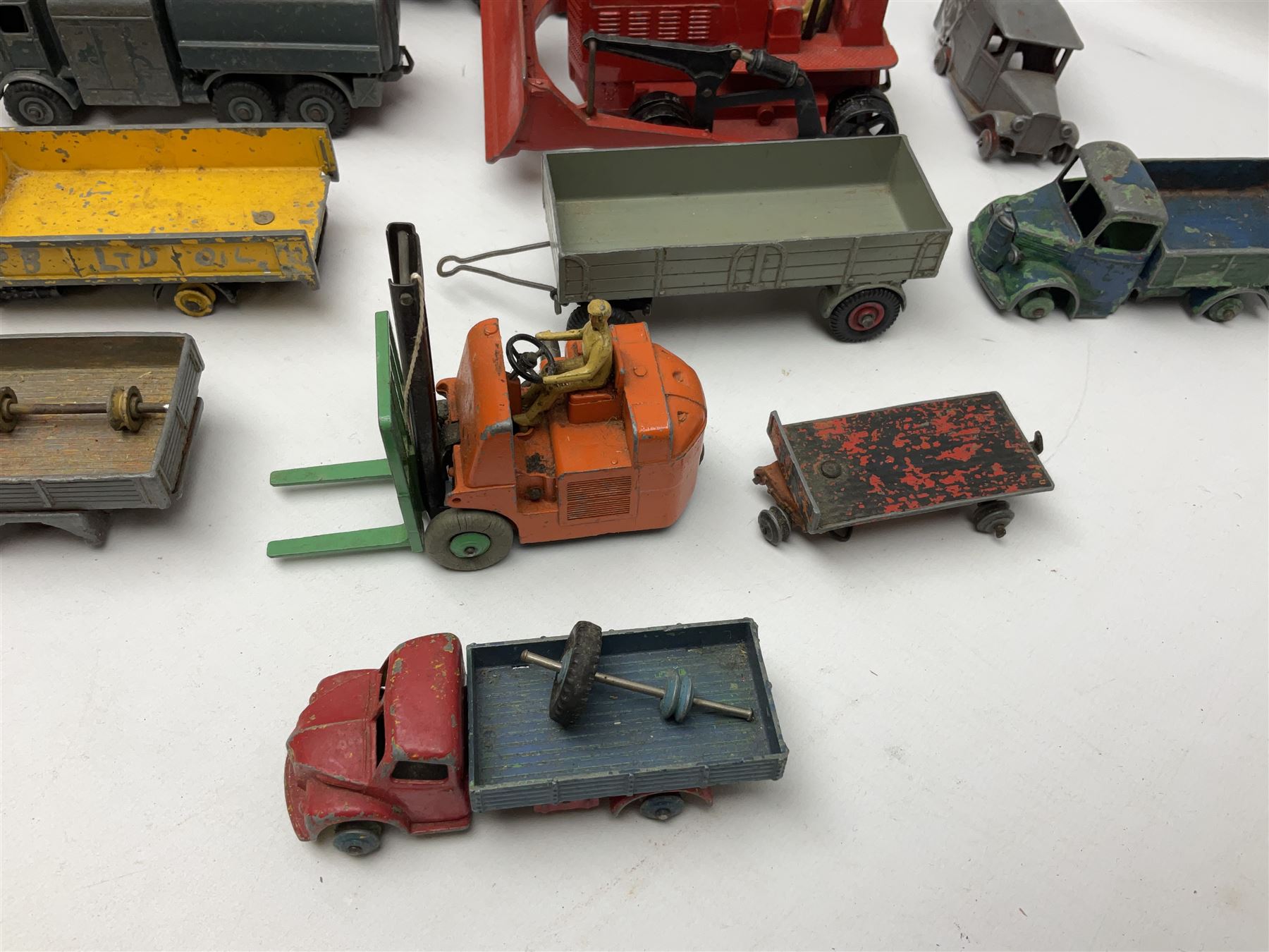 Dinky - twenty-six unboxed and playworn die-cast models including Foden Regent Tanker, two Foden lorries, Pressure Refueller No.642, Snow Plough, Elevator Loader, Foden Dump Truck, Blaw Knox Bulldozer and other commercial vehicles